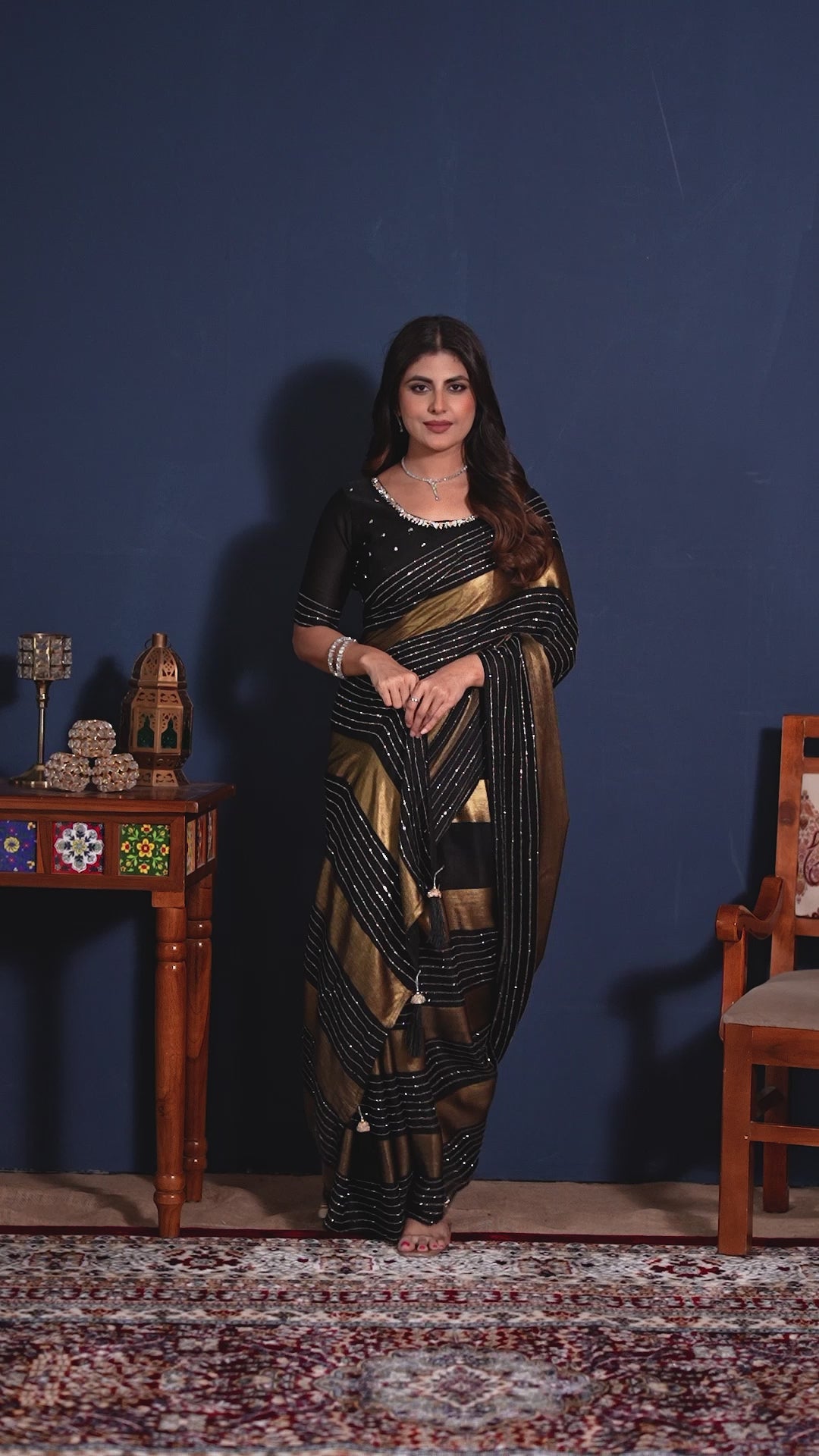 Video of the black and golden designer saree with shimmering stripes